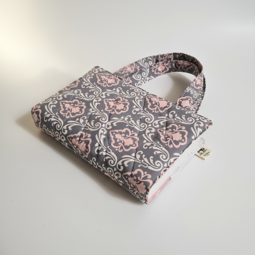Custom handmade quilted fabric Bible sleeve in grey and pink damask, clean product shot
